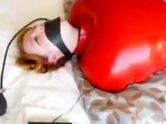 Inflatable red latex sack and gagged mouth