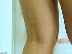 Hot young nympho pleases herself in the shower