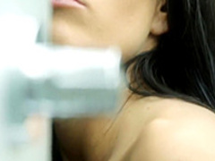 Foxy brunette finger fucks her bald cunny while taking a shower