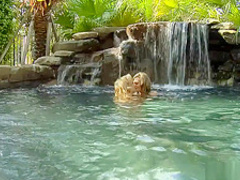 Sexy lesbians play in a beautiful pool and toy their wet pussies