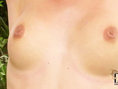 Teen blonde masturbates with a pink toy in backyard