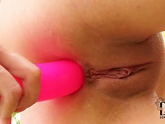 Teen blonde masturbates with a pink toy in backyard