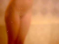 Playboy beauty posing in a shower