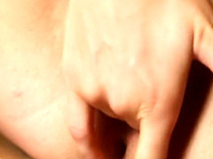 Sexy brunette stands in a sauna and finger fucks her warm twat