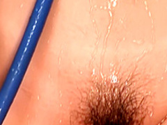 Sensual Oriental babe shows off her lovely boobs and her hairy peach