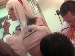 Asian in cosplay jacks one cock while riding another