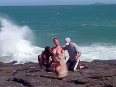 Interracial threesome at the beach