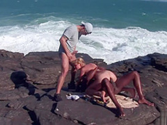 Interracial threesome at the beach