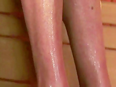 A granny takes care of a hot little brunette in the sauna