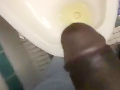 Taking a piss in the urinal at the library