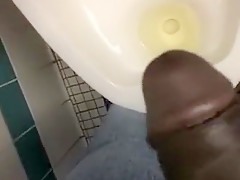 Taking a piss in the urinal at the library