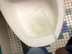 Taking a piss in the urinal at the library