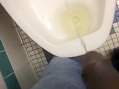 Taking a piss in the urinal at the library
