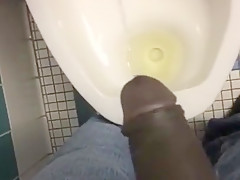 Taking a piss in the urinal at the library