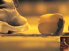 POV crushing of capsicum in shiny Doc Martens combat boots