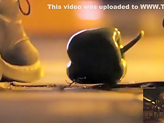POV crushing of capsicum in shiny Doc Martens combat boots
