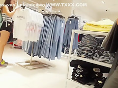 Candid voyeur teen in cheeky shorts clothes shopping