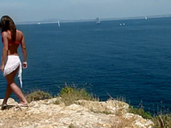 Hot babe strips on a cliff with a great view