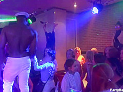 Naughty girls are taking turns sucking a handsome dancer's dick and getting fucked in the night club