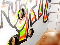 Big titted brunette is sucking a hard meat stick through a gloryhole and enjoying it quite a lot