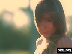 All natural teen Lillii stripping slowly on a meadow