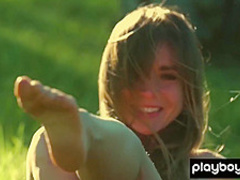 All natural teen Lillii stripping slowly on a meadow