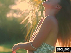 All natural teen Lillii stripping slowly on a meadow