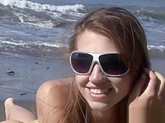 Long-legged beauty posing naked on the beach