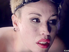 Blonde slave in gas mask gets whipped