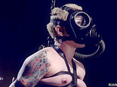 Blonde slave in gas mask gets whipped