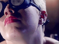 Blonde slave in gas mask gets whipped