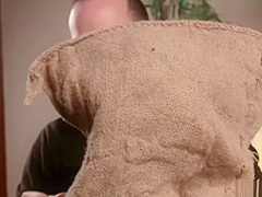 Blindfolded slave is locked in stocks