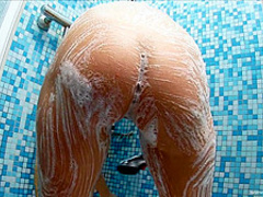 A young busty blonde in the shower