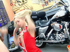 A blonde enjoys having sex in a bike garage