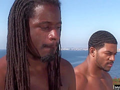 Kinky ladies and two handsome, black guys are having group sex on a huge balcony