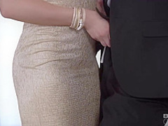 Cherry Kiss is kneeling in front of two horny guys and sucking their rock hard dicks