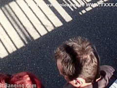 Shameless redhead takes 2 cocks in public