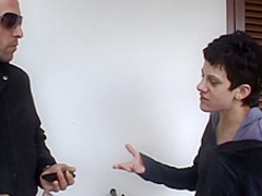 Small titted woman is kneeling on the floor and sucking two dicks, like a real pro