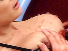 Hot babes in bikinis are touching each other in a pool filled up with jello