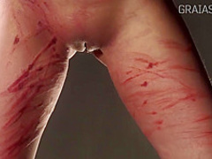 Slim lady is into BDSM and likes to get whipped very hard, while tied up tight