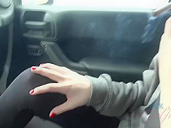Frisky brunette with full, sensual lips is smoking in the car and spreading her legs wide open