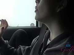 Frisky brunette with full, sensual lips is smoking in the car and spreading her legs wide open