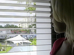 A beautiful blonde teen masturbating in bed